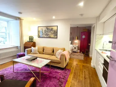 a living room with a couch and a table at Quayside in Mevagissey