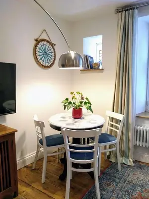 a white table with chairs and a potted plant on it at Quayside in Mevagissey