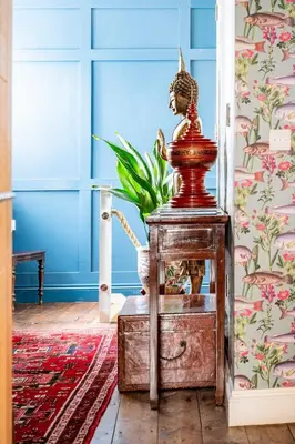 a wooden table with a statue on it in a room at Quayside in Mevagissey