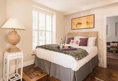 a bedroom with a large bed with a table on it at Quayside in Mevagissey