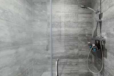 a shower with a glass door in a bathroom at The Nook - Self Serviced Accommodation in St Ives