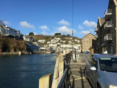 a car parked on a bridge next to a river at Sand Dune in Looe