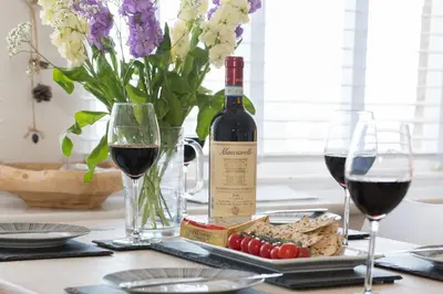 a table with two glasses of wine and a plate of food at The Loft in St Ives
