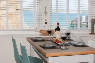a table with a bottle of wine and glasses at The Loft in St Ives