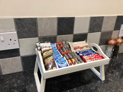 a shelf filled with food and drinks on a counter at Seaclusion in St Austell