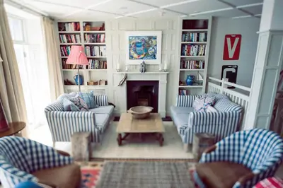 a living room with two chairs and a fireplace at St Mawes Hotel in Saint Mawes