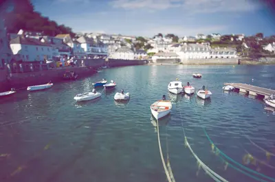 a group of boats are docked in a harbor at St Mawes Hotel in Saint Mawes