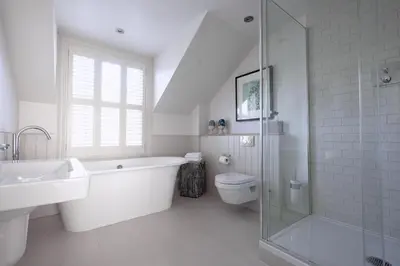 a white bathroom with a tub and a toilet and a sink at St Mawes Hotel in Saint Mawes