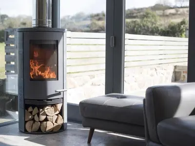 a fireplace in a living room next to a couch at chyreen@marazion in Marazion