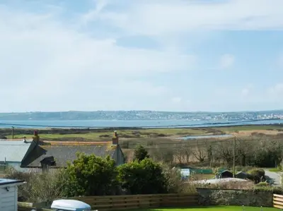 a view of a field and a body of water at chyreen@marazion in Marazion