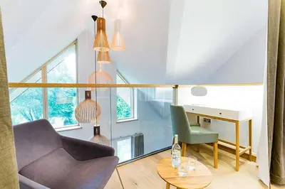 a living room with a chair and a desk at Budock Vean Hotel and Spa in Falmouth