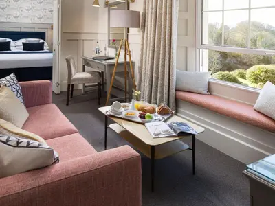 a living room with a couch and a table at Budock Vean Hotel and Spa in Falmouth