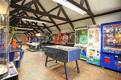 a room filled with lots of arcade games at Atlantic Reach Resort in Newquay