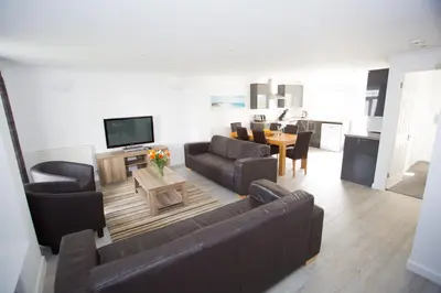 a living room with a couch and a table at Atlantic Reach Resort in Newquay