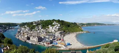 a village on an island in a body of water at Sand Martin in Looe