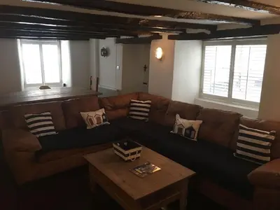 a living room with a brown couch and a coffee table at The Old Vicarage in Looe