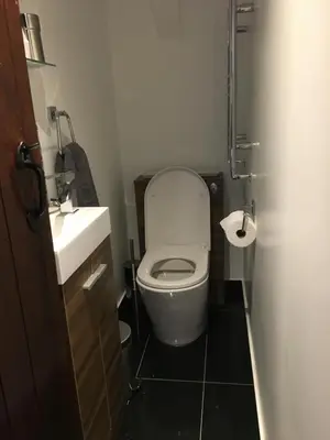 a small bathroom with a toilet and a sink at The Old Vicarage in Looe