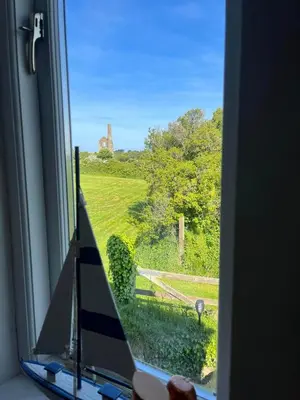 a window with a view of a green field at Wrens Nook in St. Agnes