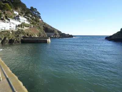 a body of water with houses on a hill at The Lodge, Polgooth in St Austell