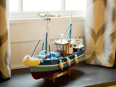 a toy boat is sitting on the floor in a room at Museum Apartment in Looe