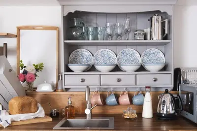 a kitchen counter with dishes on a shelf at St Kew Escapes Nr Port Isaac in Saint Kew