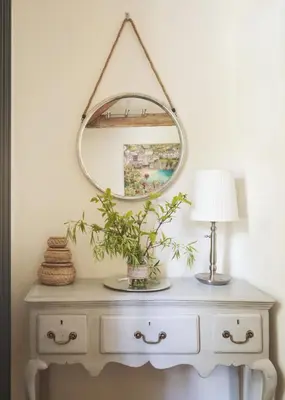 a mirror on top of a dresser with a lamp at St Kew Escapes Nr Port Isaac in Saint Kew