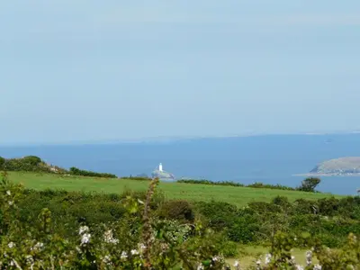 a field with a view of the ocean at The Little Cabin in St Ives