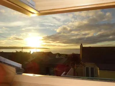 a view of the sunset from the balcony of a house at Gwithian, Sea Dream Beach Chalet in Gwithian