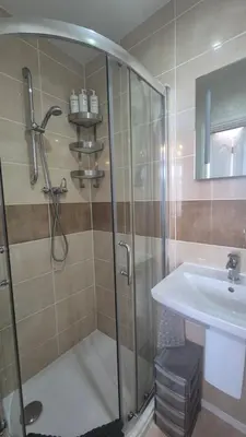 a bathroom with a shower and a sink at Tregarthen - Adult Only in Newquay