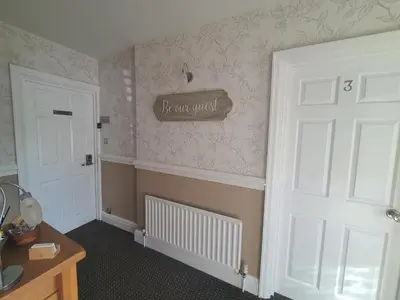 a room with a door and a sign on the wall at Tregarthen - Adult Only in Newquay
