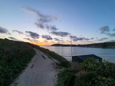 a dirt road next to a body of water at Tregarthen - Adult Only in Newquay