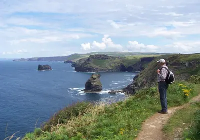 a man standing on a hill looking at the ocean at Old Newham Farm in Camelford