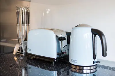 two toasters sitting on top of a kitchen counter at Re-imagined Stone Barns in the Country Near the Coast in Padstow