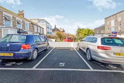 two cars parked next to each other in a parking lot at SeaQuest 5 in Newquay