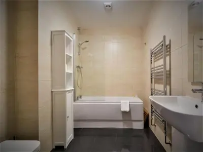 a bathroom with a tub and a toilet and a sink at SeaQuest 5 in Newquay