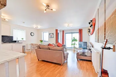 a living room with a couch and a table at SeaQuest 5 in Newquay