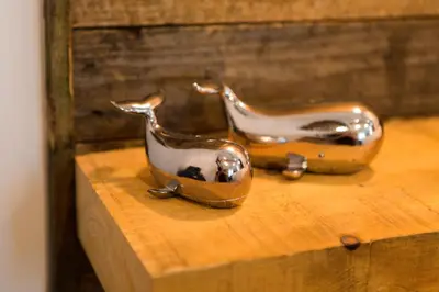 a pair of shoes sitting on a wooden shelf at The Lighthouse Penthouse, Studio and Holiday Home in St Ives