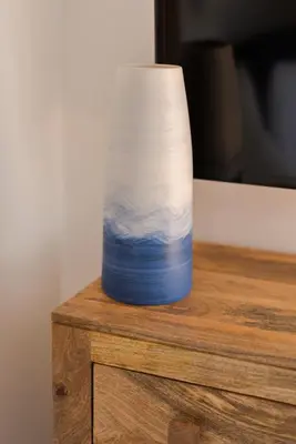 a blue and white vase sitting on top of a table at The Lighthouse Penthouse, Studio and Holiday Home in St Ives
