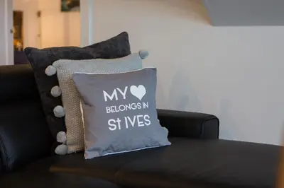 a pillow that says my bloons st wes on a couch at The Lighthouse Penthouse, Studio and Holiday Home in St Ives