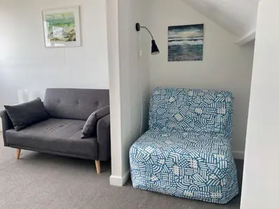 a living room with a couch and a chair at Coast Accommodation in St Ives