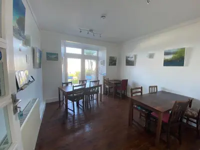 a living room with tables and chairs and a dining room at Coast Accommodation in St Ives