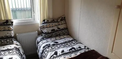 a bedroom with a bed with black and white pillows at C28 Angels retreat in Par