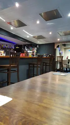 a restaurant with a large wooden table and chairs at C28 Angels retreat in Par