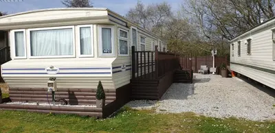 a white trailer parked next to a house at C28 Angels retreat in Par
