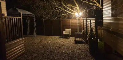 a backyard at night with a fence and a light at C28 Angels retreat in Par