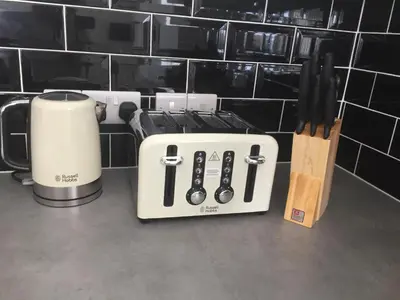 a toaster and a coffee maker on a counter at SeaQuest 8 in Newquay