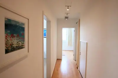 a hallway with a painting on the wall at Porthpean Apartment in Charlestown