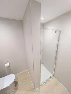 a shower stall in a bathroom with a toilet at Porthpean Apartment in Charlestown