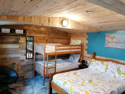 a bedroom with two bunk beds in a cabin at Pensalda Guest House in Newquay