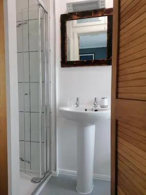 a bathroom with a sink and a mirror at Pensalda Guest House in Newquay